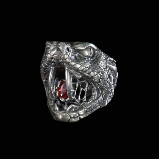 Men's oxidized silver snake ring, Fanged Resolve, with ruby gemstone for strength and transformation.