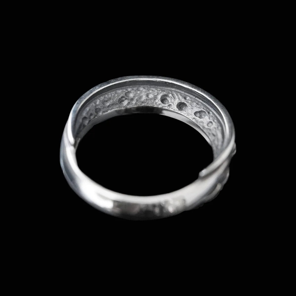 Top-down view of Lunation Eye Ring, clearly showing the sequence of carved eyes/moon phases around the band.