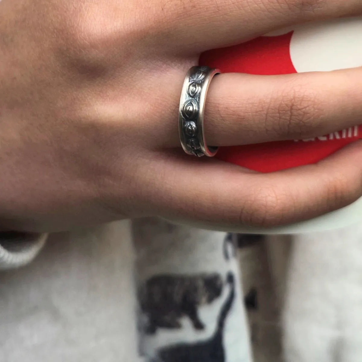 Lunation Eye Ring worn on a hand, demonstrating the band's size, fit, and the distinct lunar texture aesthetic when worn.