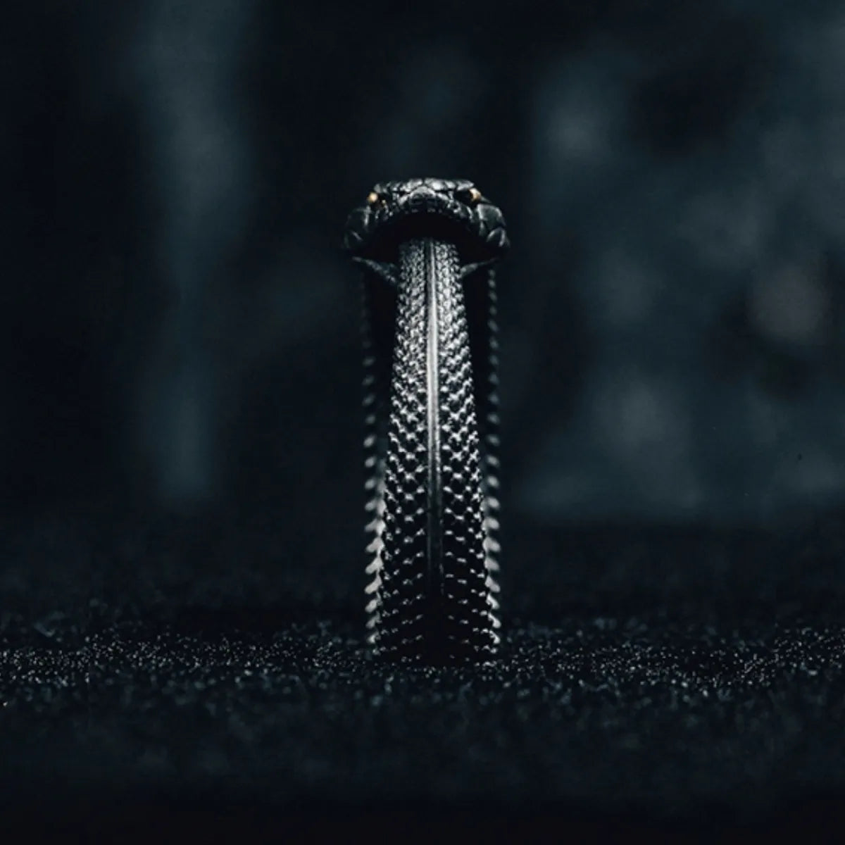 Close-up of the snake's head on the Fate Eclipse Ring, focusing on the intricate scales and the single, piercing yellow eye.