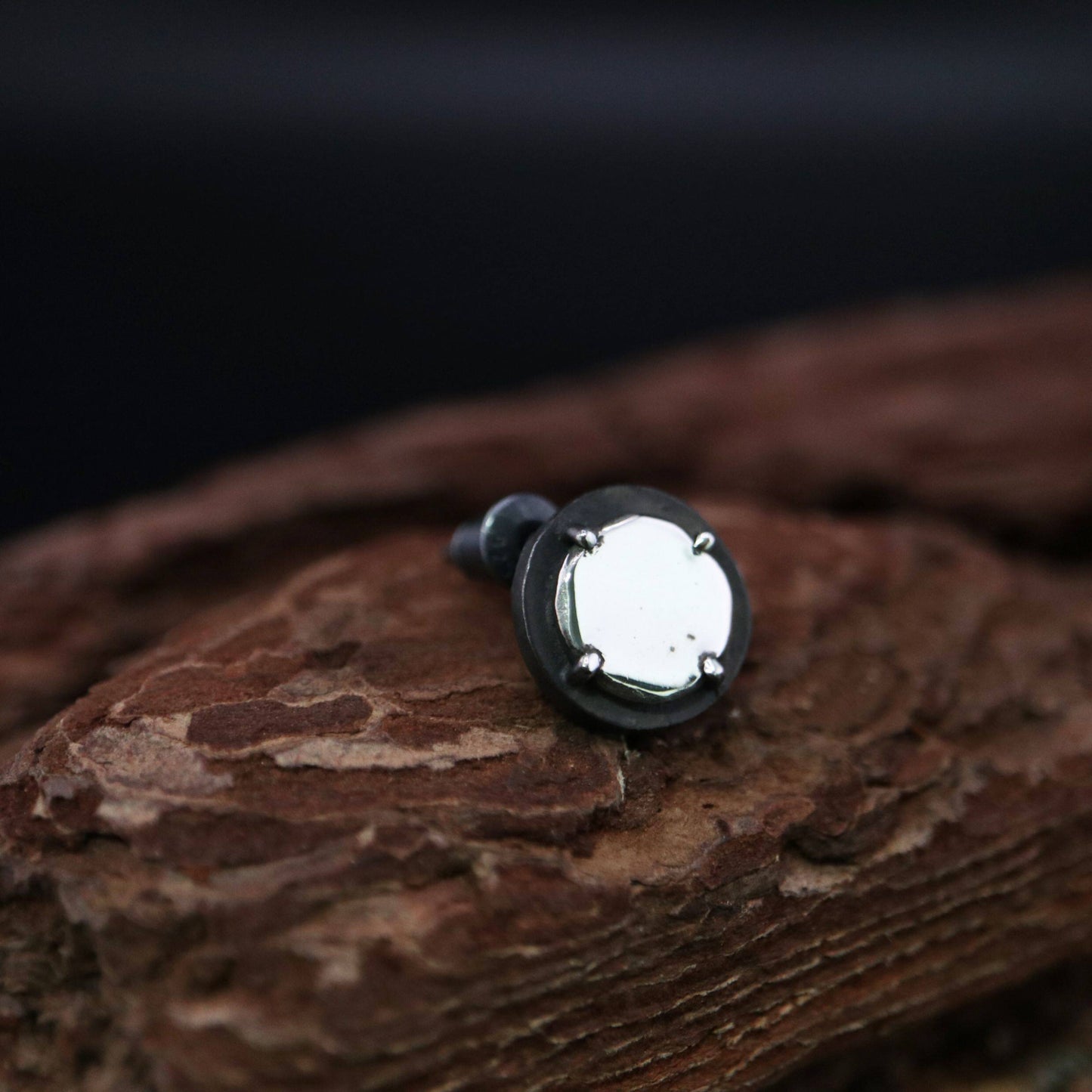 Handmade 925 sterling silver stud earring featuring a polished mirror-like center in an oxidized silver industrial frame.