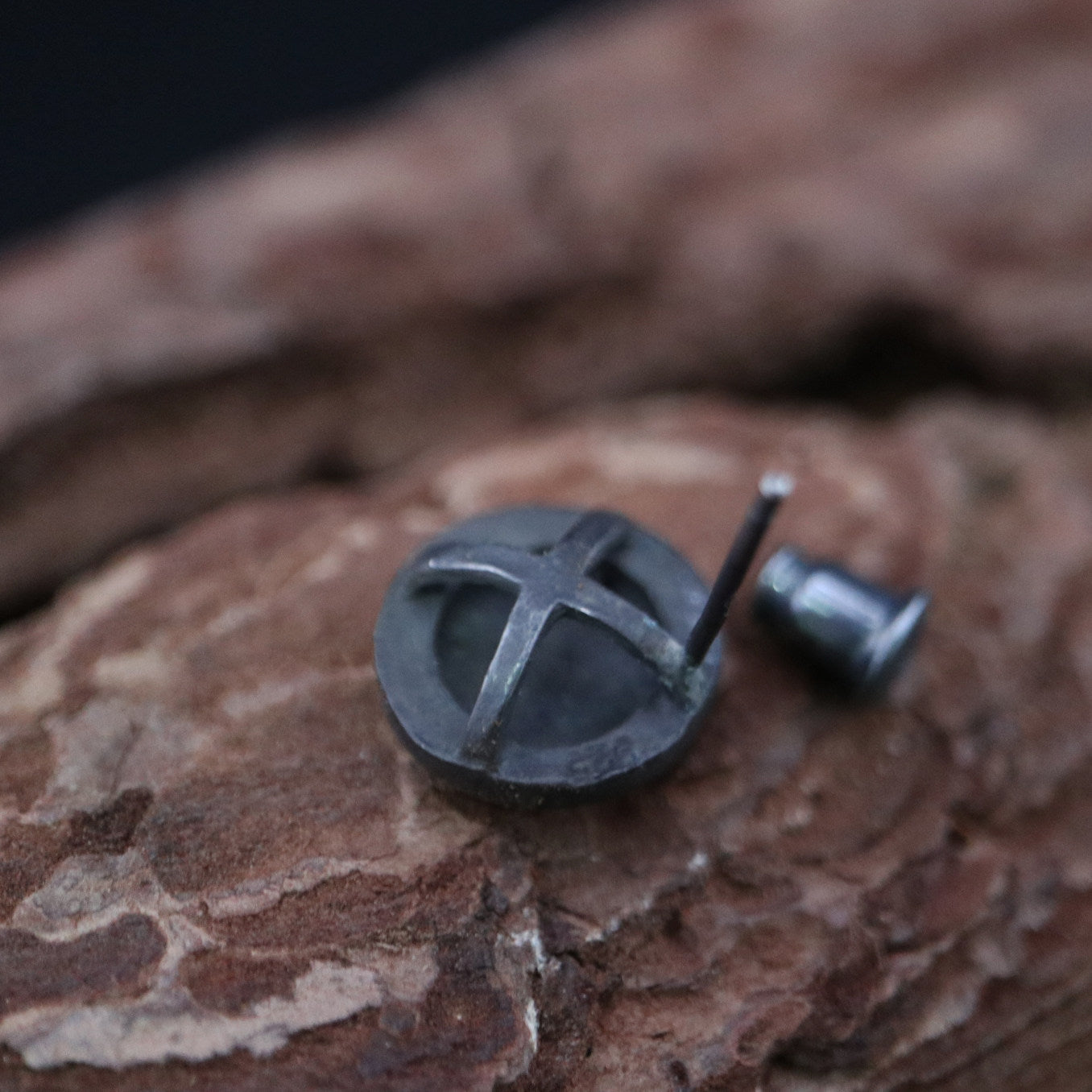 Handmade 925 sterling silver stud earring featuring a polished mirror-like center in an oxidized silver industrial frame.