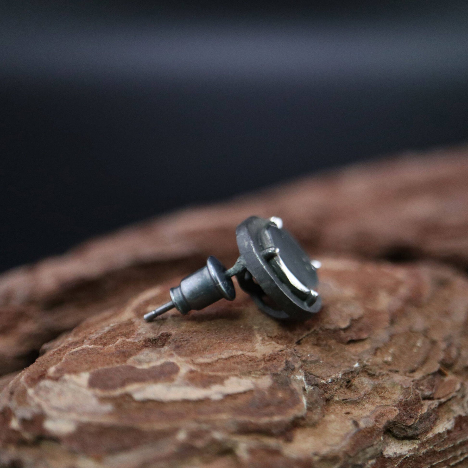 Handmade 925 sterling silver stud earring featuring a polished mirror-like center in an oxidized silver industrial frame.
