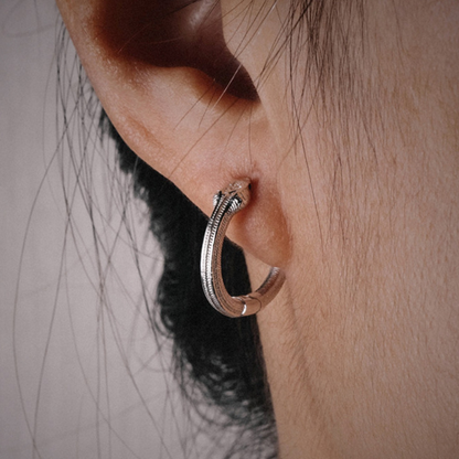 Handmade 925 sterling silver ear cuff in a gothic rattlesnake design with detailed scales and an polished silver finish.