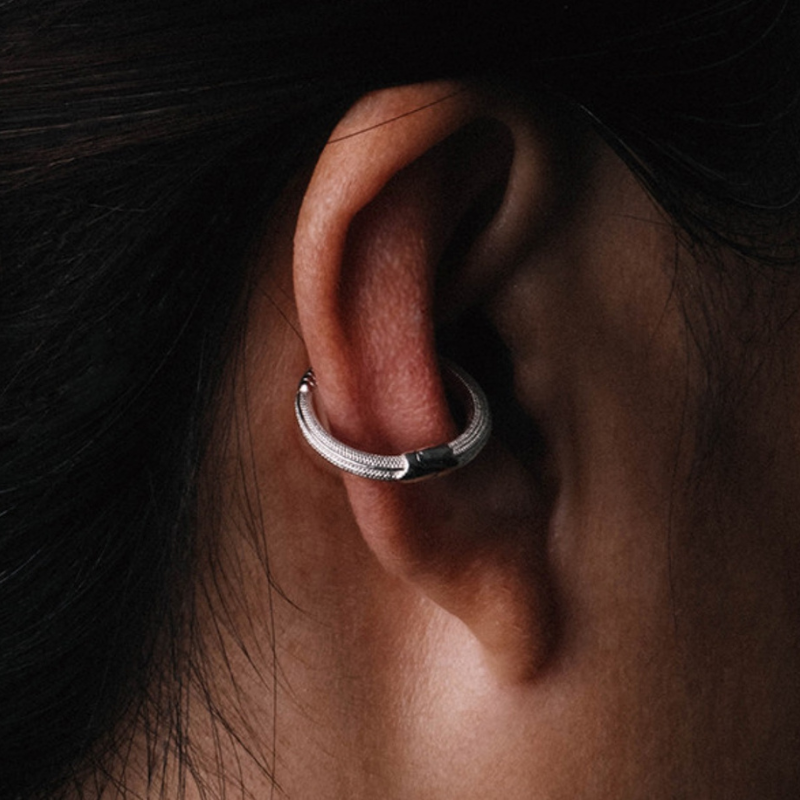 Handmade 925 sterling silver ear cuff in a gothic rattlesnake design with detailed scales and an polished silver finish.