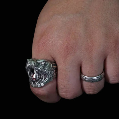 Men's oxidized silver snake ring, Fanged Resolve, with ruby gemstone for strength and transformation.