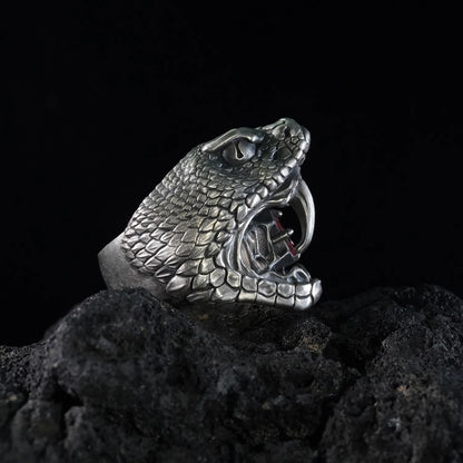 Men's oxidized silver snake ring, Fanged Resolve, with ruby gemstone for strength and transformation.