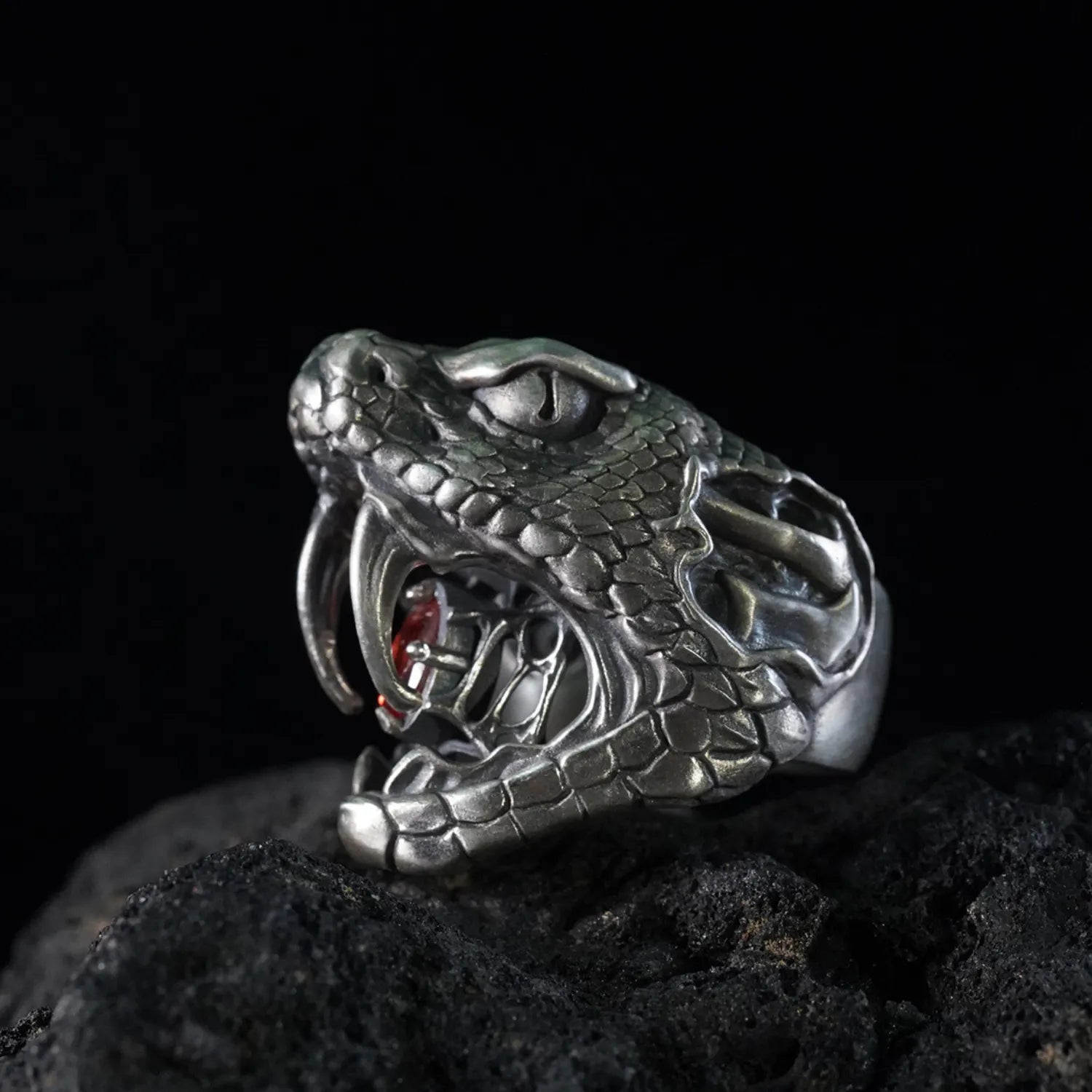 Men's oxidized silver snake ring, Fanged Resolve, with ruby gemstone for strength and transformation.