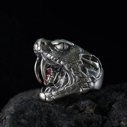 Men's oxidized silver snake ring, Fanged Resolve, with ruby gemstone for strength and transformation.