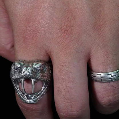 Men's oxidized silver snake ring, Fanged Resolve, with ruby gemstone for strength and transformation.