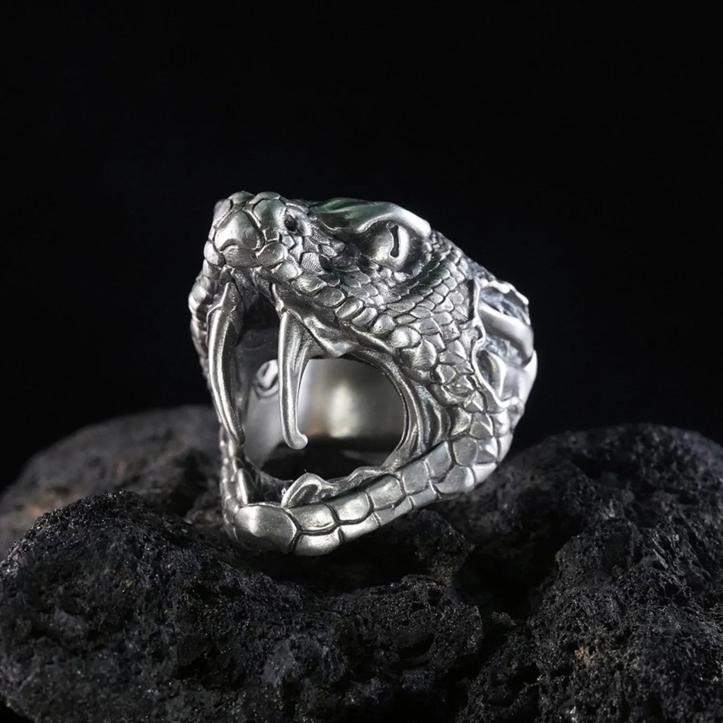 Men's oxidized silver snake ring, Fanged Resolve, with ruby gemstone for strength and transformation.