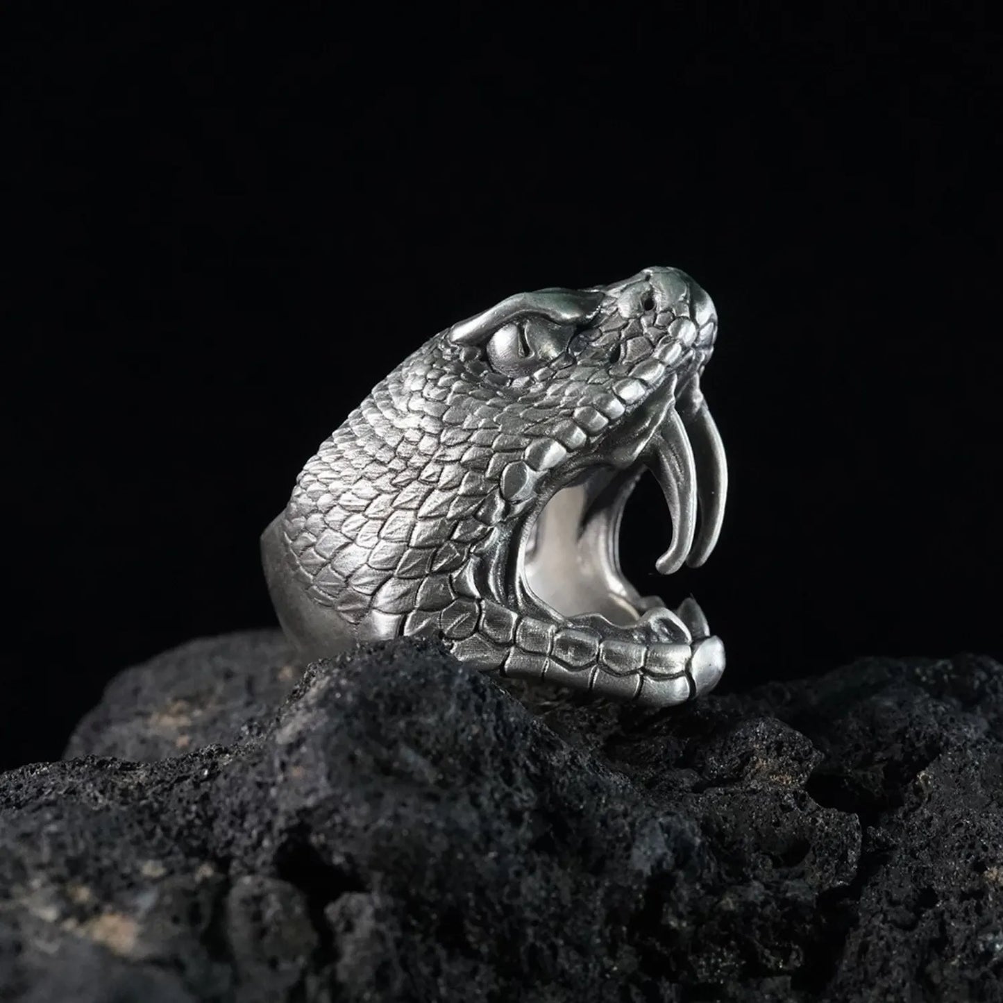 Men's oxidized silver snake ring, Fanged Resolve, with ruby gemstone for strength and transformation.