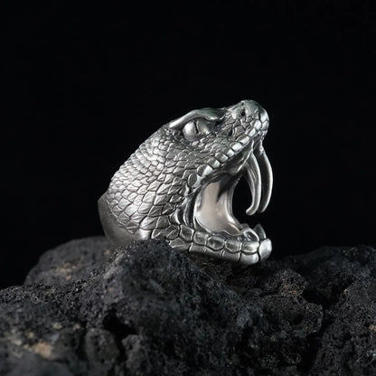 Men's oxidized silver snake ring, Fanged Resolve, with ruby gemstone for strength and transformation.